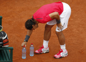 Nadal of Spain arranges bottles near his chair on the court during his quarter-final match against his compatriot Almagro at the French Open tennis tournament at the Roland Garros stadium in Paris